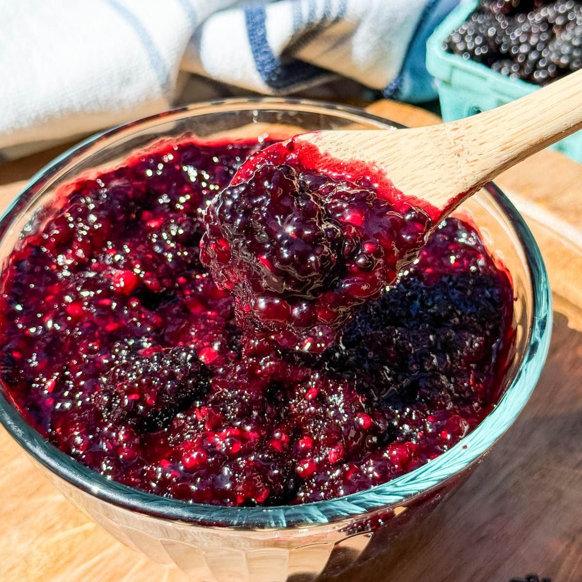 blackberry filling in a clear bowl with a spoon