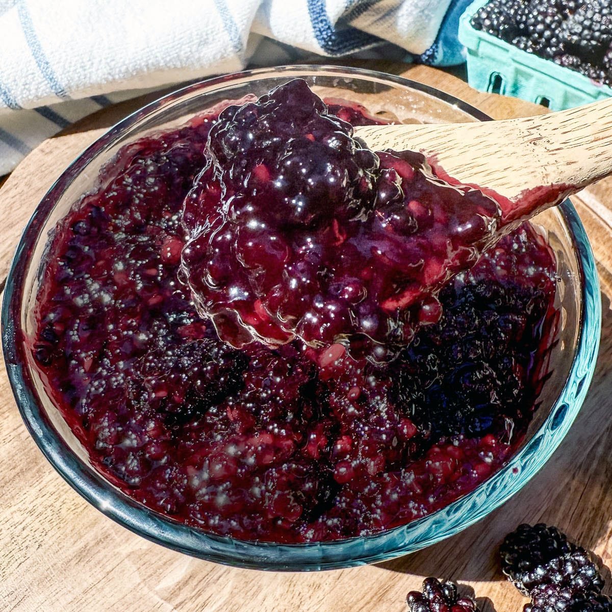 closeup of blackberry filling in a clear bowl with a spoon