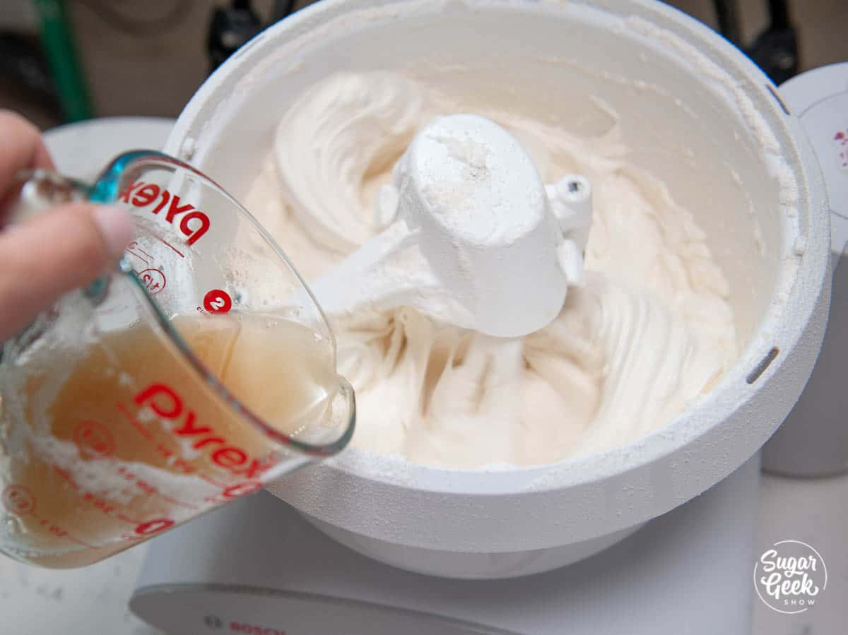 adding egg white mixture to pink champagne cake batter