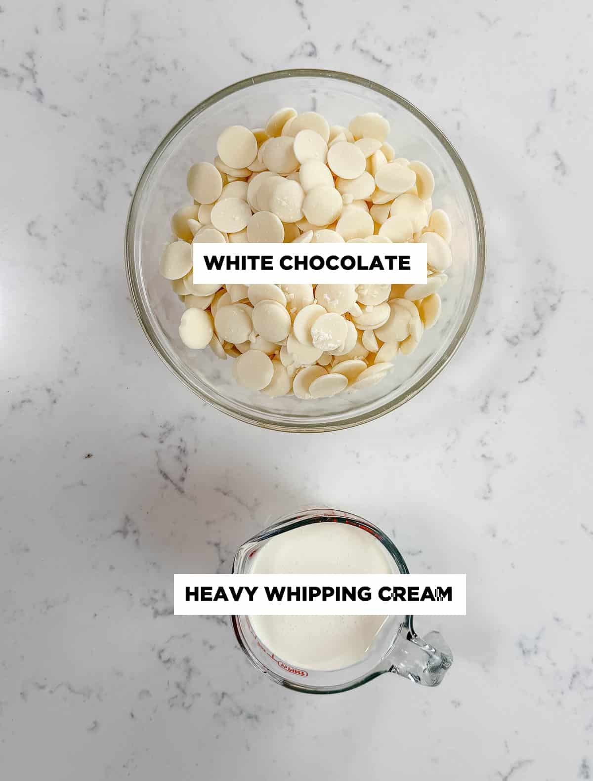 White chocolate ganache ingredients in clear glass bowls on a white countertop.