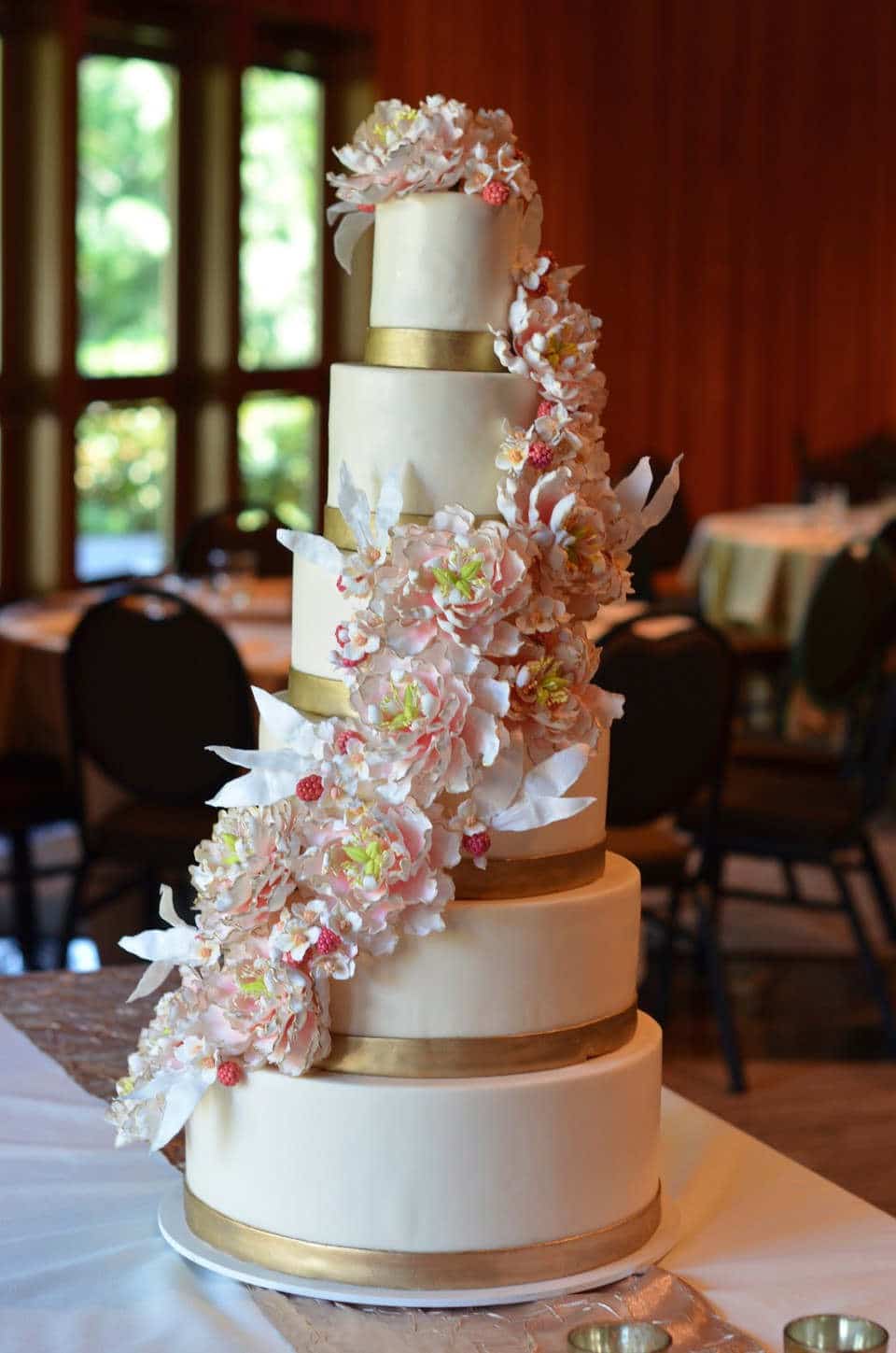 6 tier wedding cake with gold bands and gumpaste peony