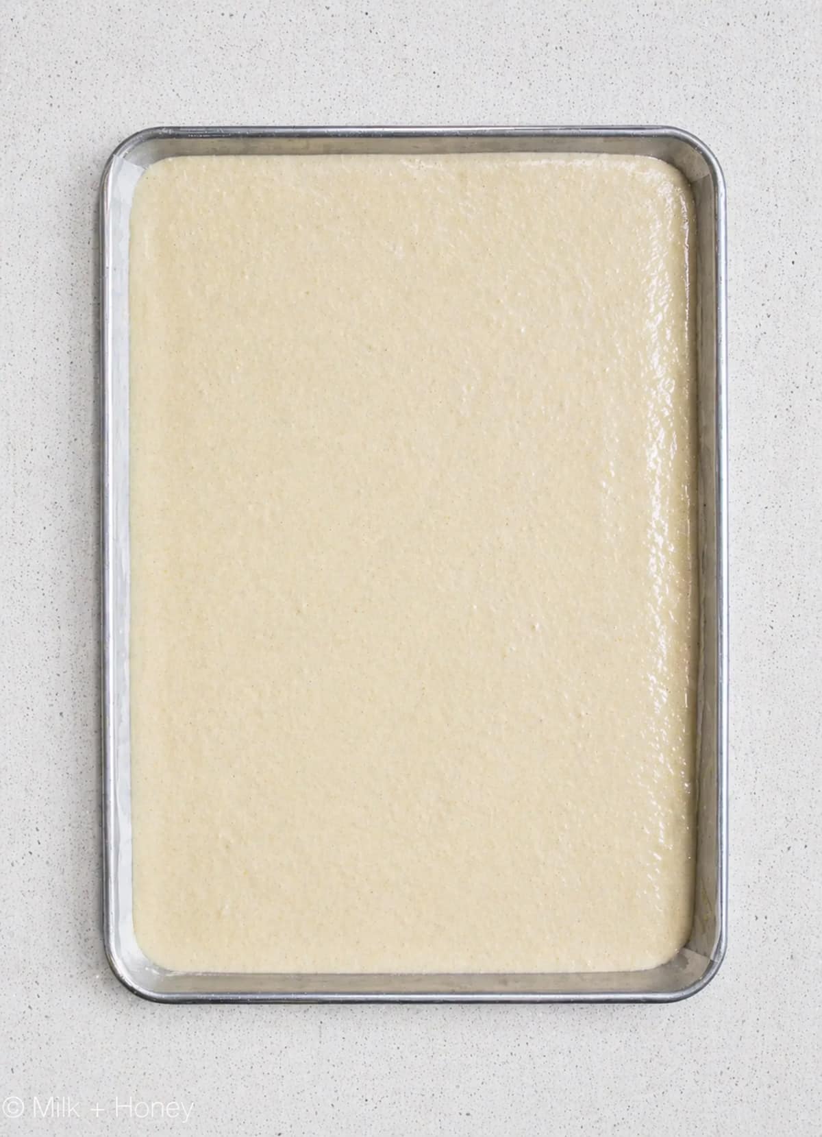 Joconde cake batter in a cake pan