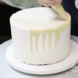 how to pour white chocolate ganache drip onto a cake