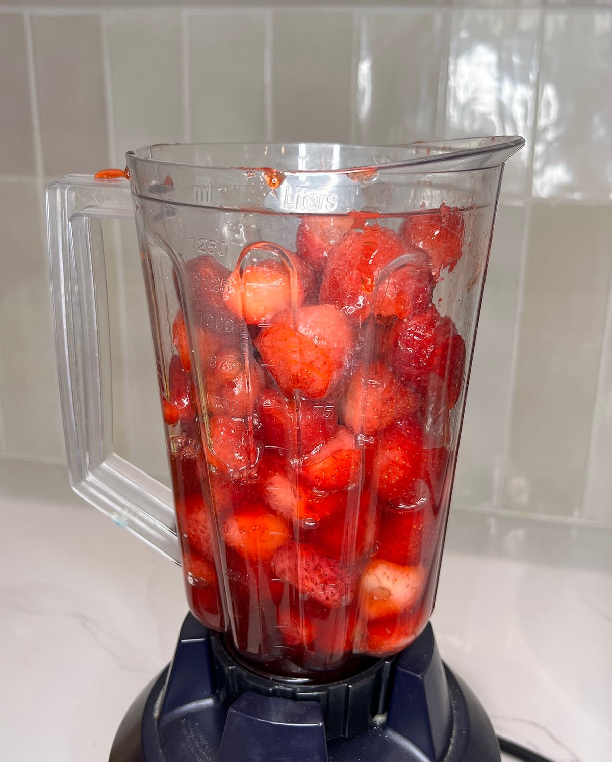 close up of strawberries in a blender
