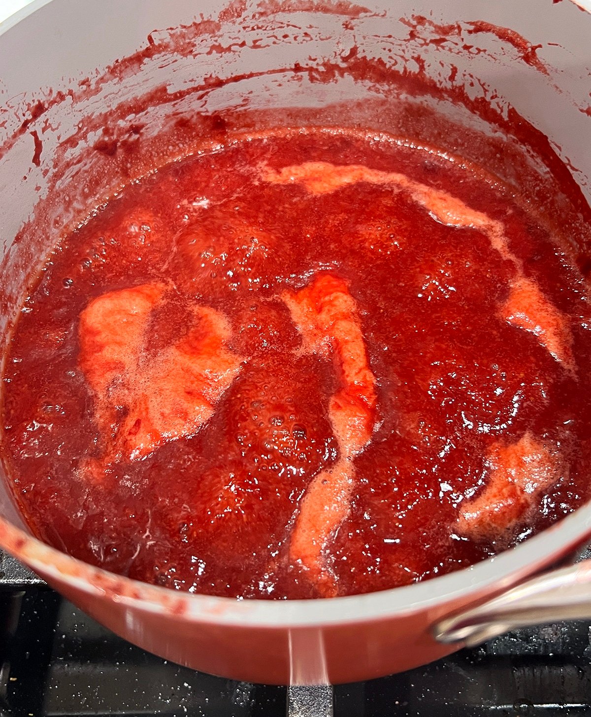 close up of bubbling strawberry reduction