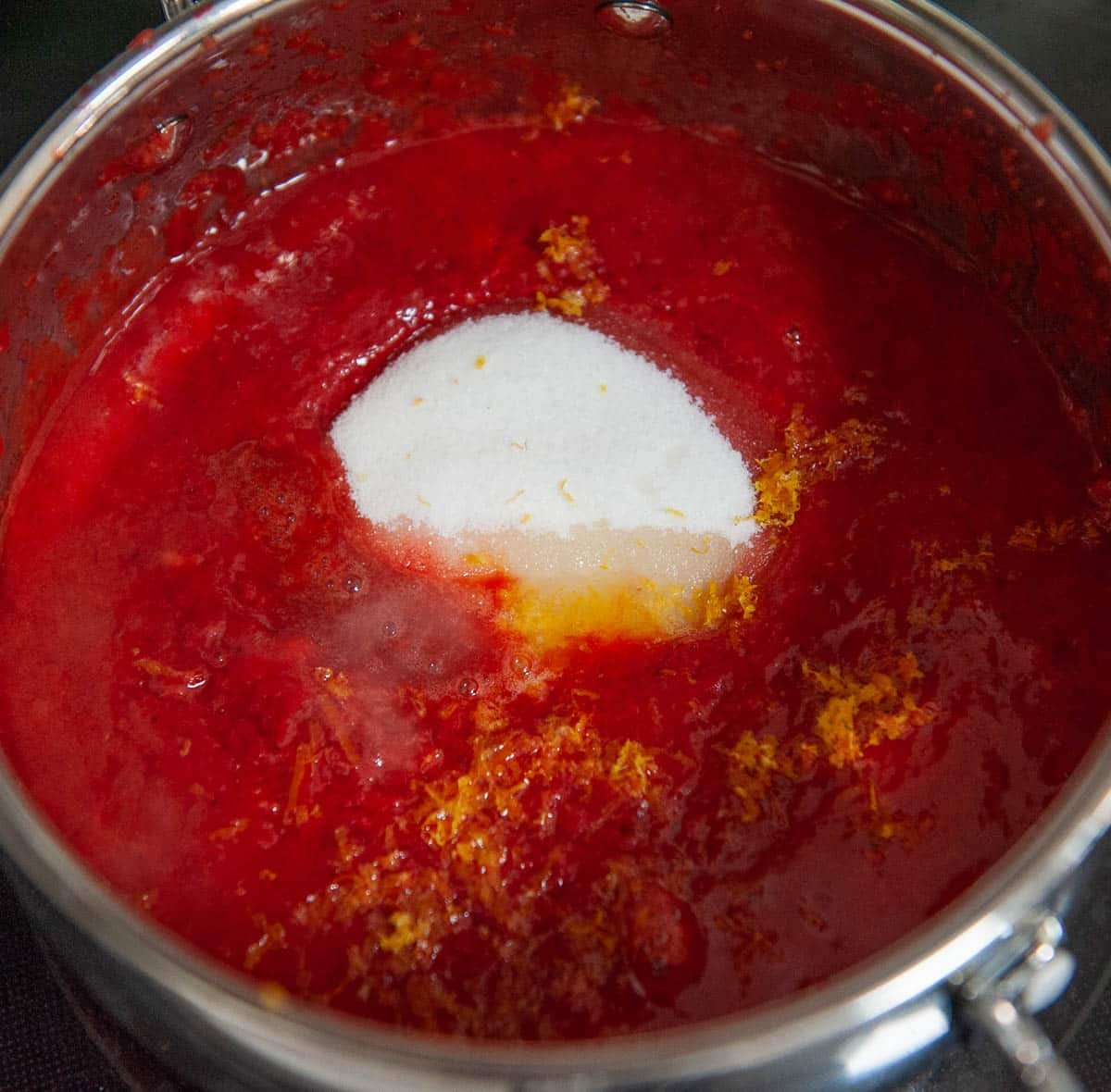 close up of strawberry reduction ingredients in a saucepan
