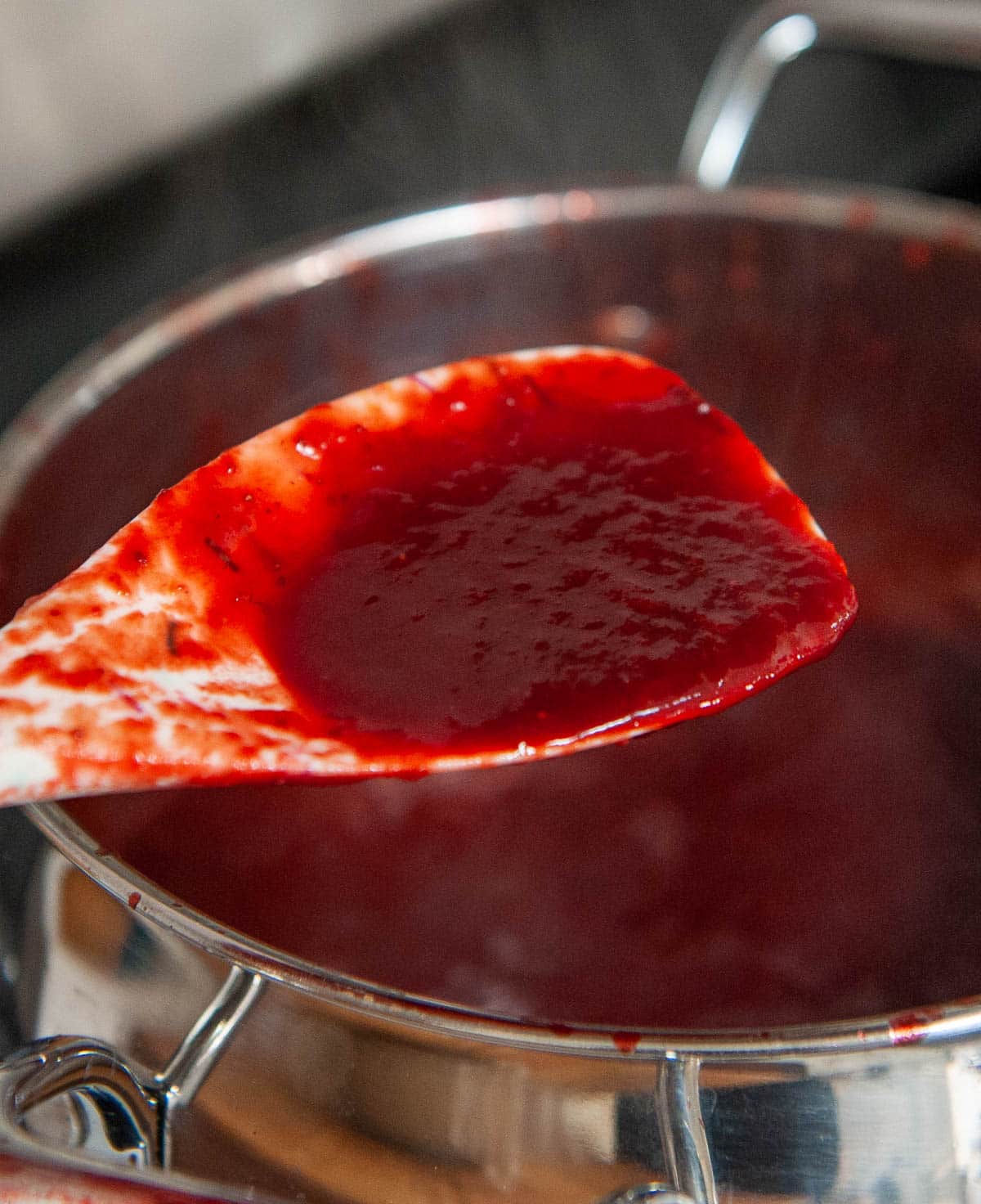 Close up of strawberry reduction on a spoon