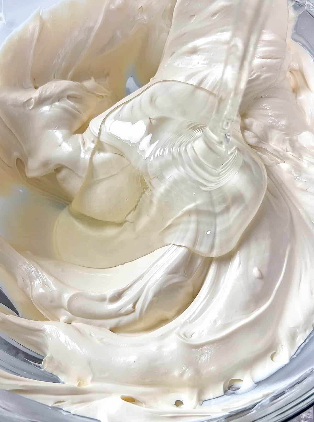 Close up of corn syrup and melted white chocolate in a bowl.