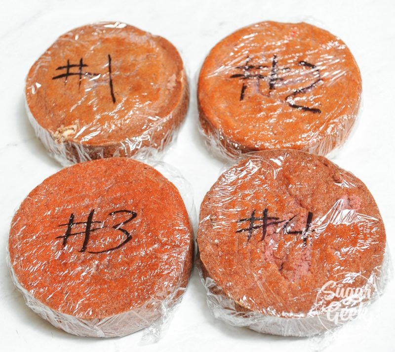 Four different strawberry cake layers wrapped in plastic wrap and numbered 1-4.