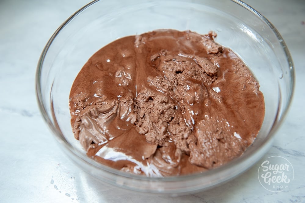 partially melted chocolate buttercream in glass bowl
