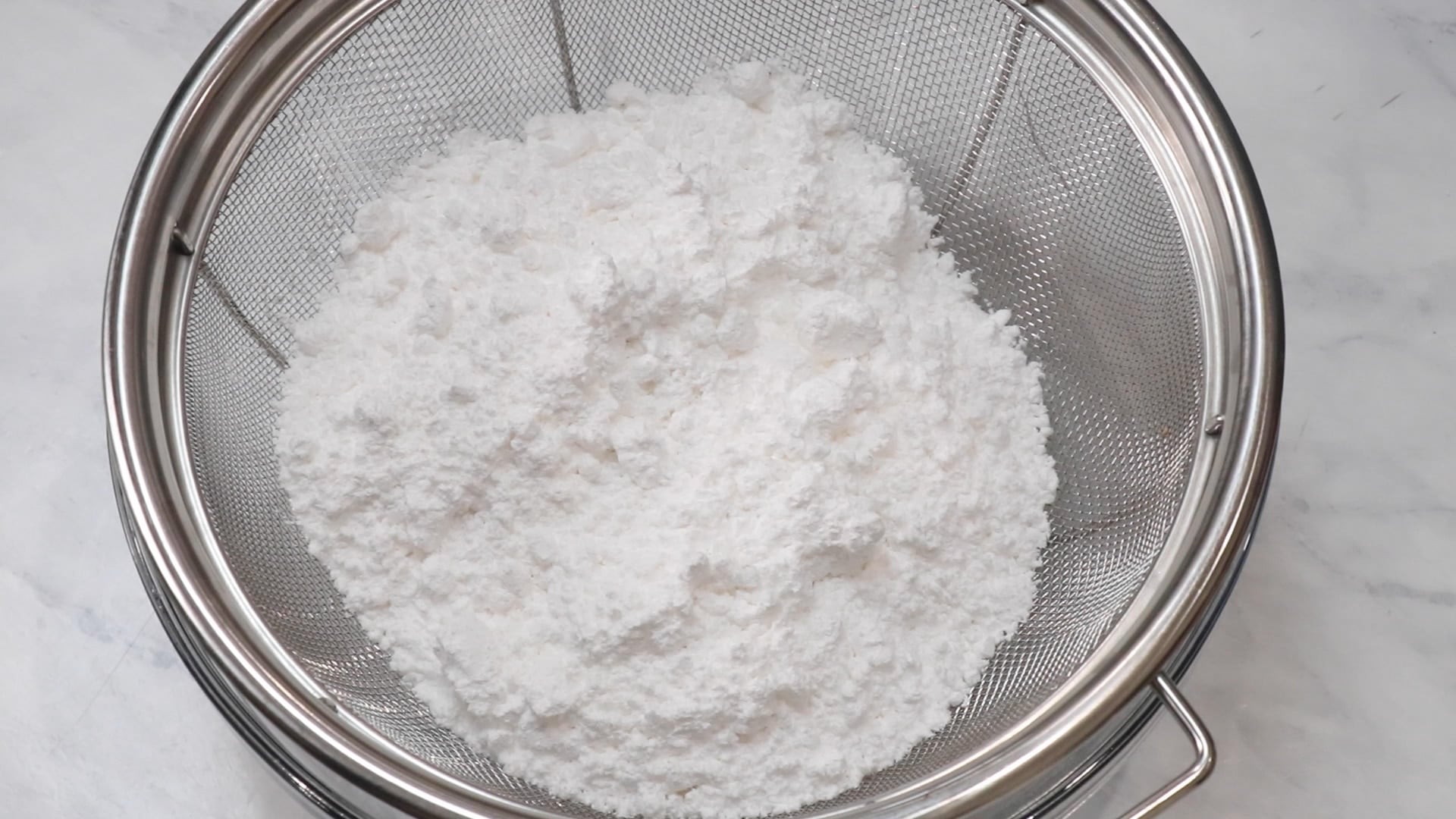 powdered sugar in a sieve