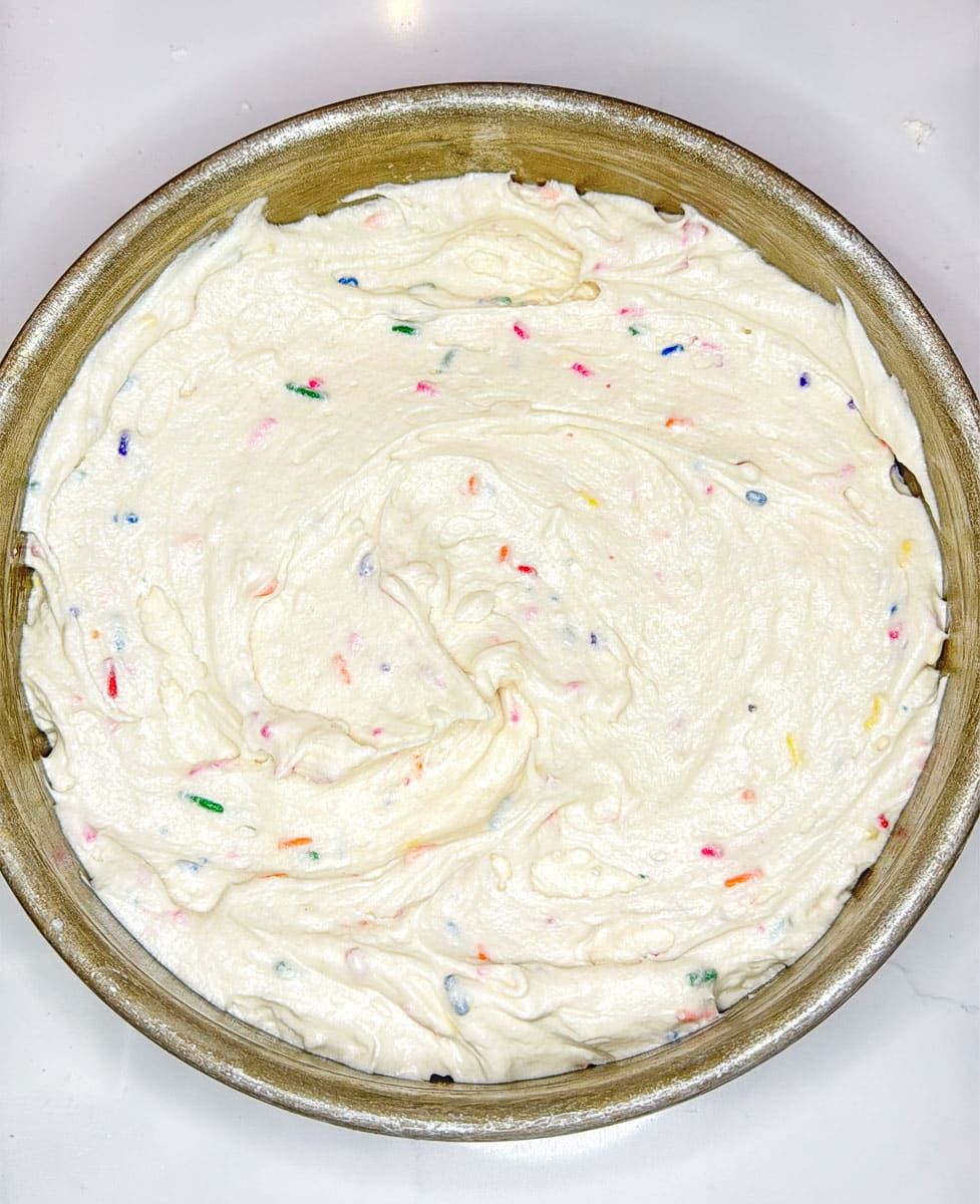close up of funfetti cake batter in a cake pan