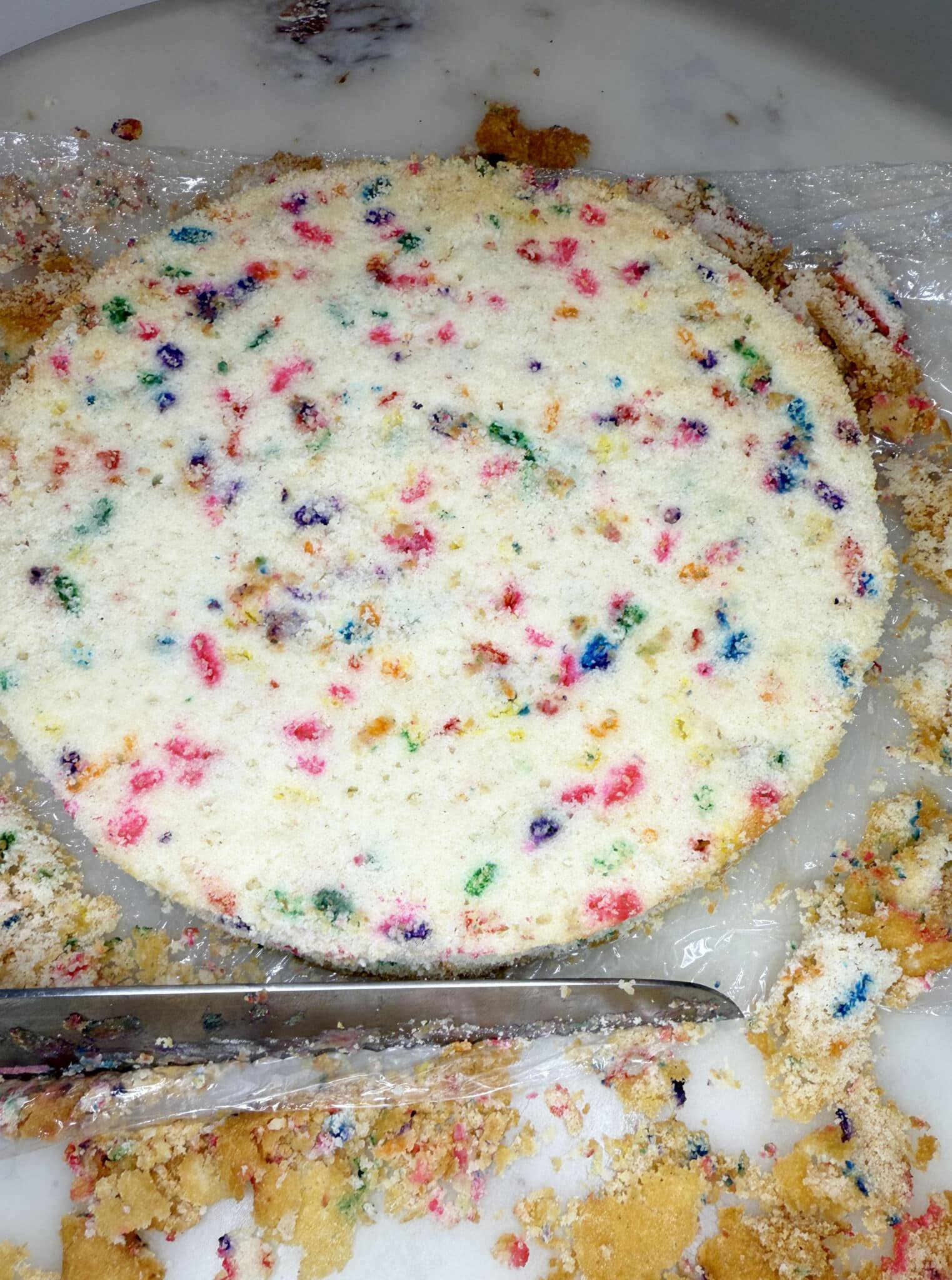 close up of cake getting brown bits trimmed off