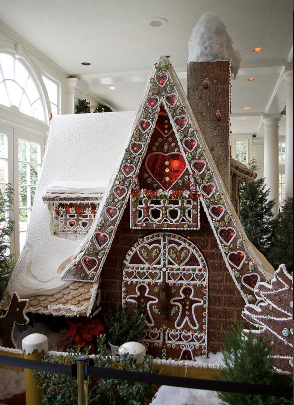 lovely A-frame gingerbread house with amazing piped doors and sugar glass windows