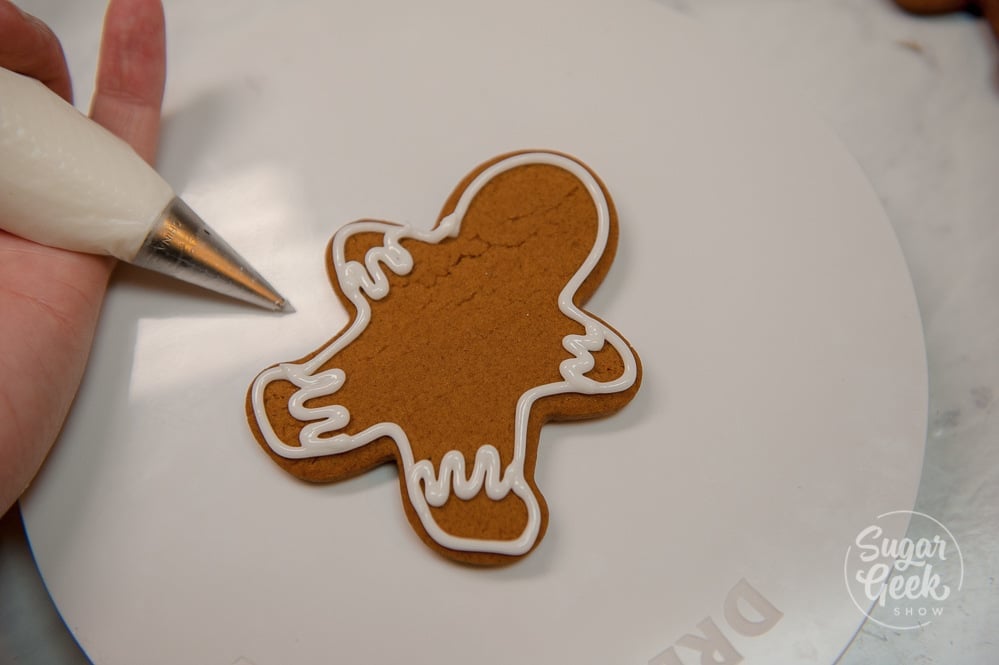 Add some royal icing cuffs and pants to your gingerbread cookie