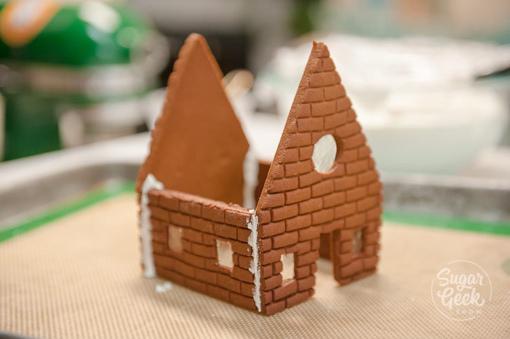 Crumbled gingerbread house with the word "FAIL" across it in big, red letters. 