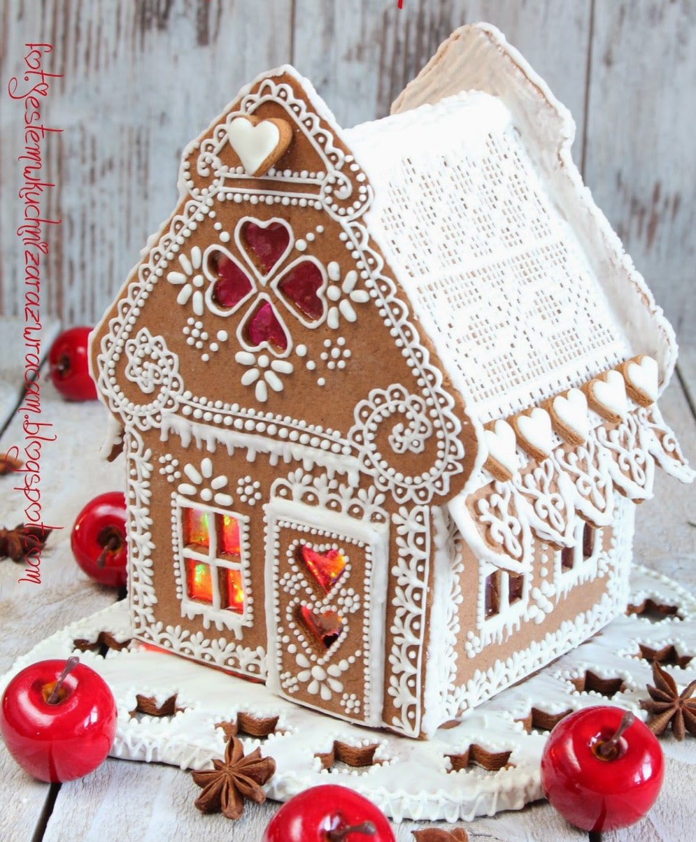 What a beautiful gingerbread house! Delicate royal icing piping and melted sugar windows. So elegant