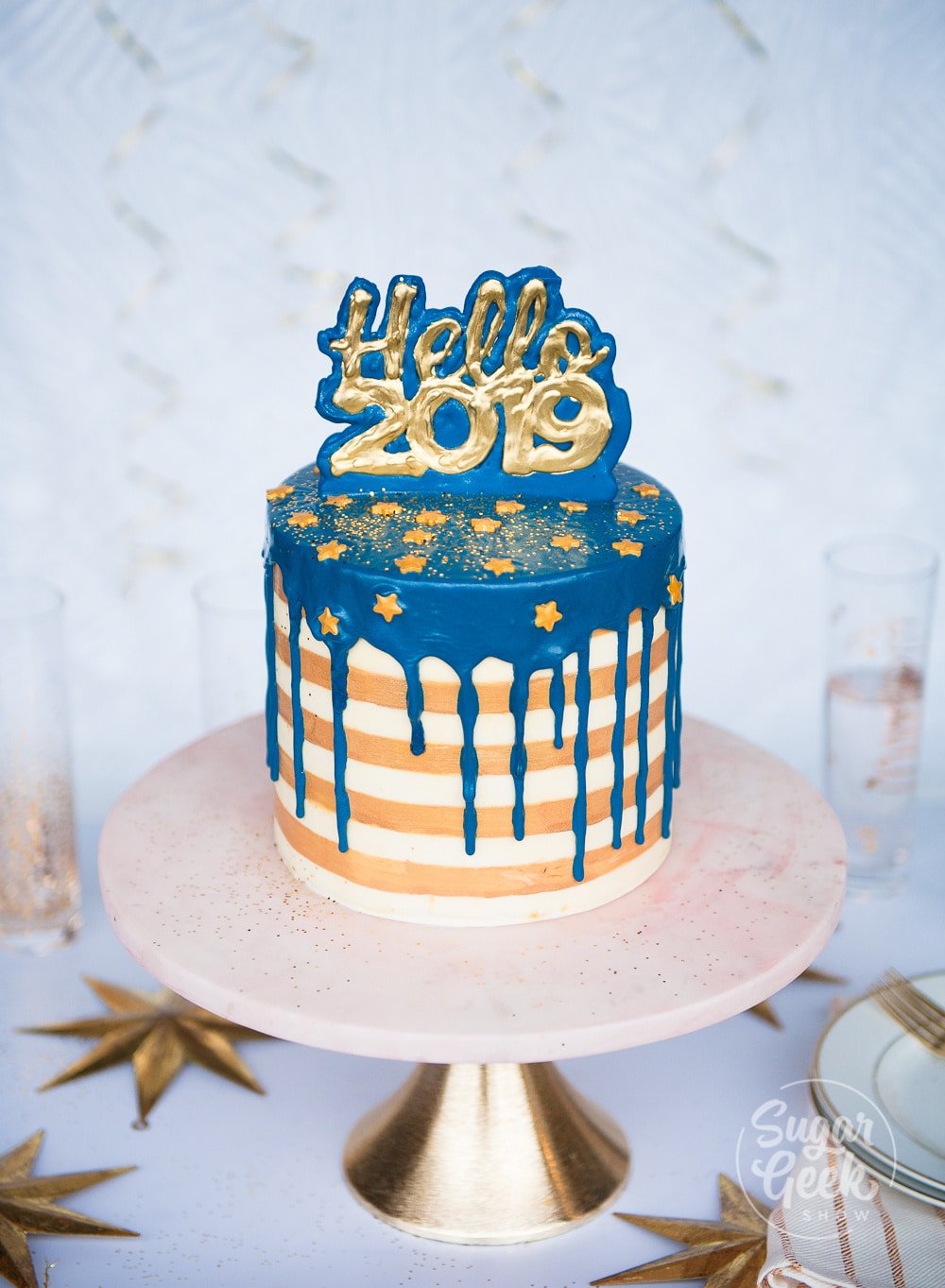 New years eve cake with buttercream stripes and water ganache drip and chocolate cake topper