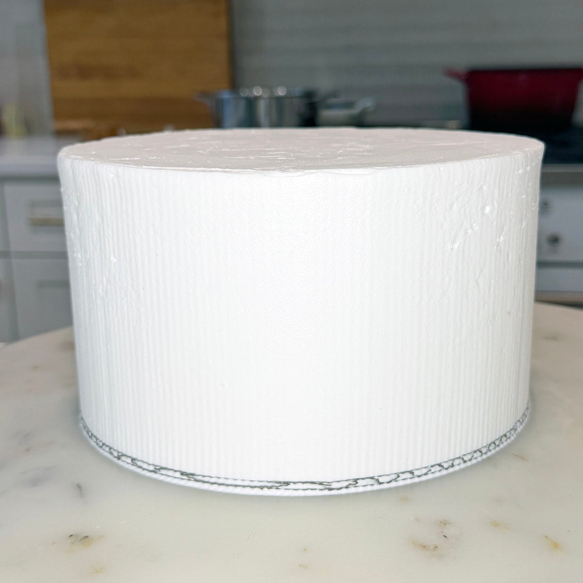 Smooth frosted cake with final buttercream coat