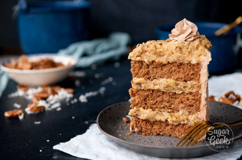 closeup of german chocolate cake with coconut pecan frosting and chocolate swiss meringue buttercream frosting