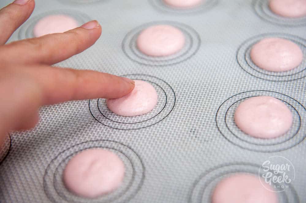 strawberry macaron with skin developing on the surface