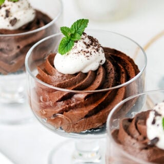 close up of chocolate mousse in a clear cup