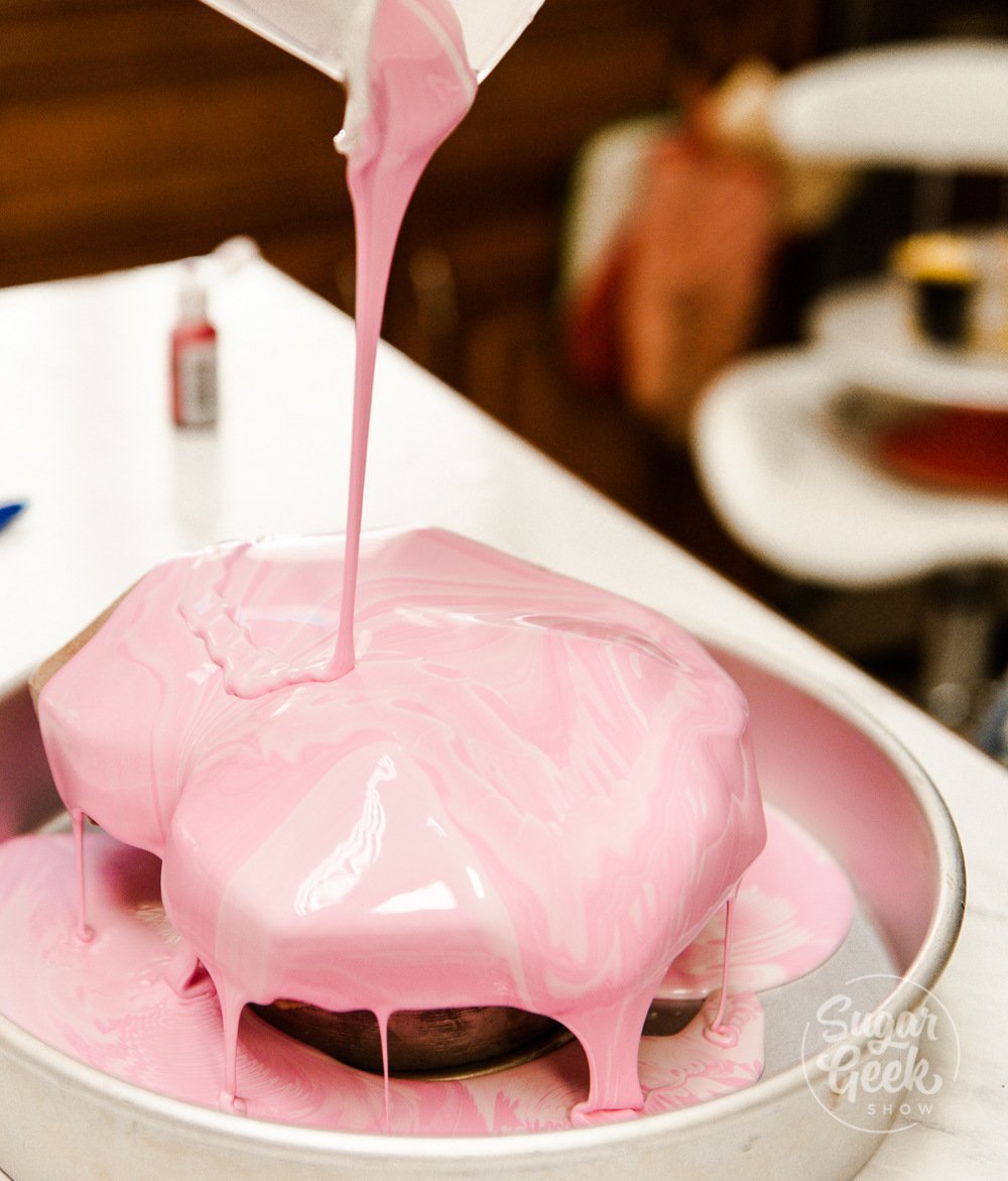 pouring glaze over frozen mousse cake