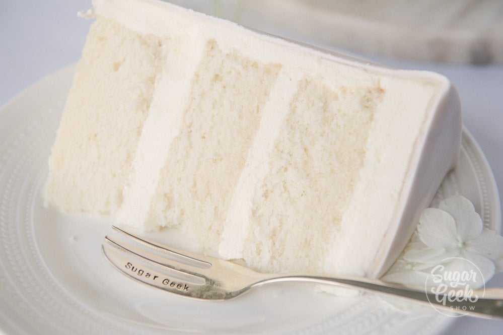 close up of WASC white almond sour cream cake, the best doctored box mix recipe for white cake