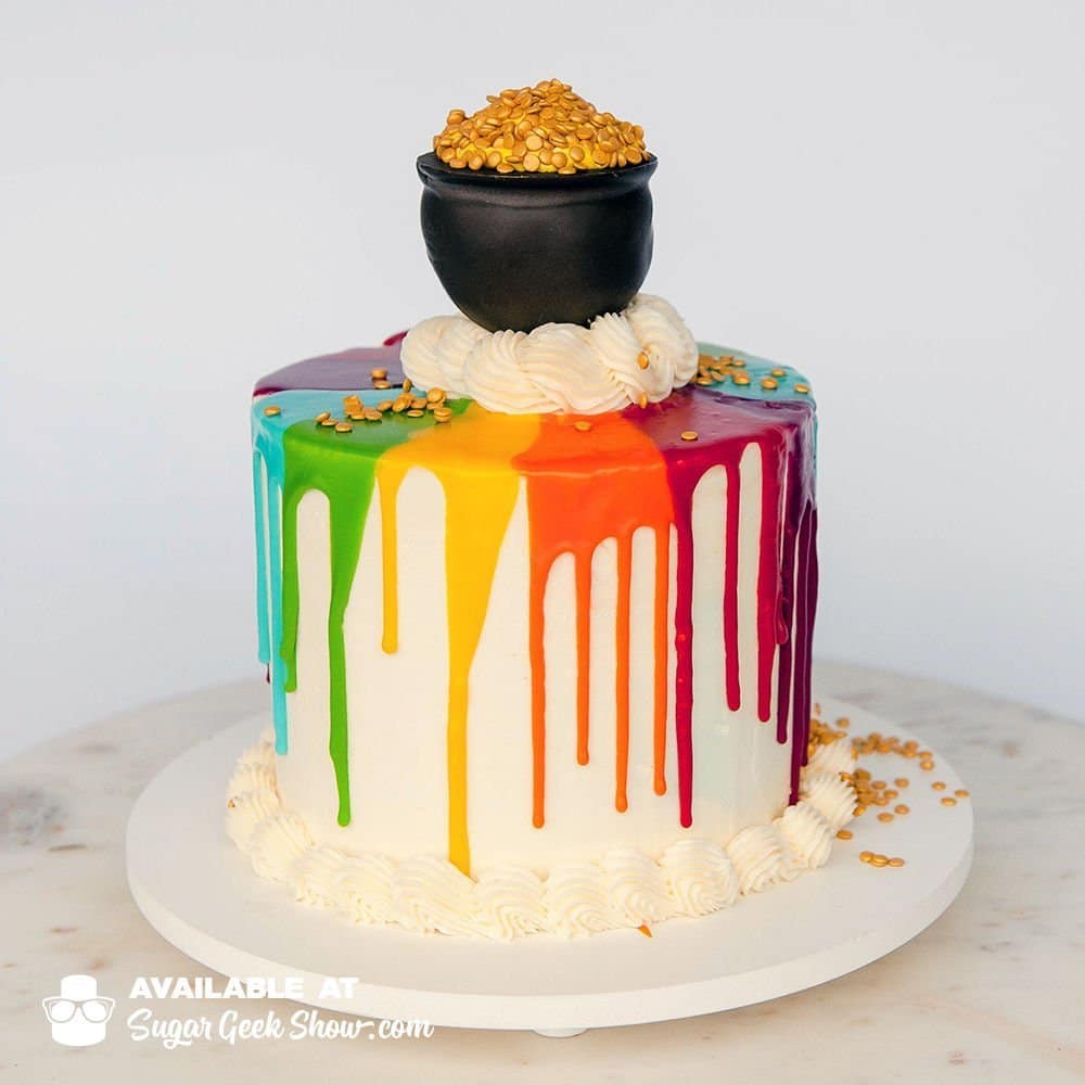 rainbow pot of gold cake for saint patrick's day. Green velvet cake with rainbow buttercream inside. Covered in a rainbow water ganache and topped with a fun pot of gold cake pop
