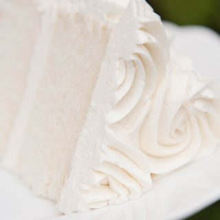 Slice of cake with ermine frosting laying on a cake plate.