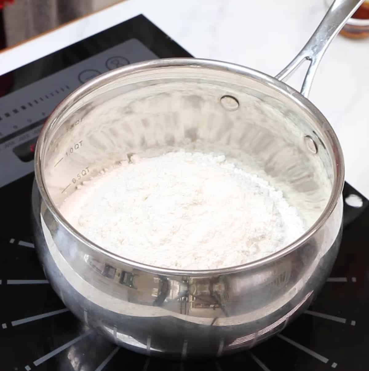 Flour and sugar in a metal saucepan.