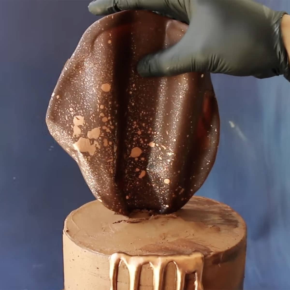 close up of chocolate sail on top of a cake