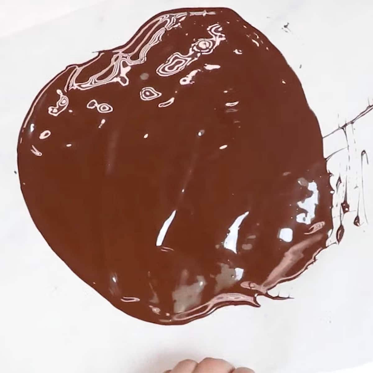 tempered chocolate spread on parchment paper