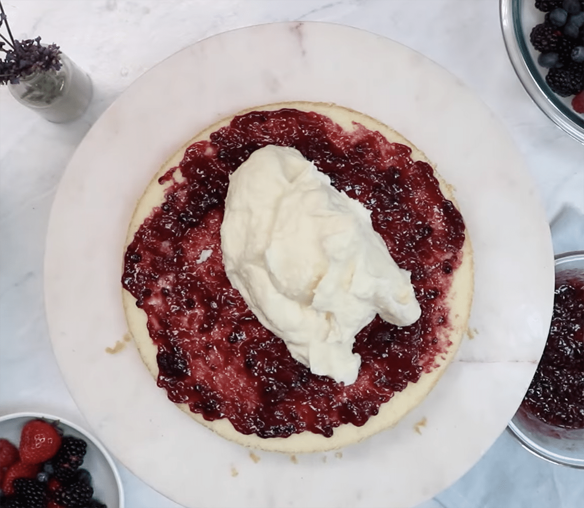 Cake layer with berry filling and chantilly cream dollop on top