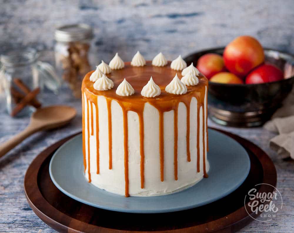 Applesauce cake frosted with cream cheese frosting and a caramel sauce drip