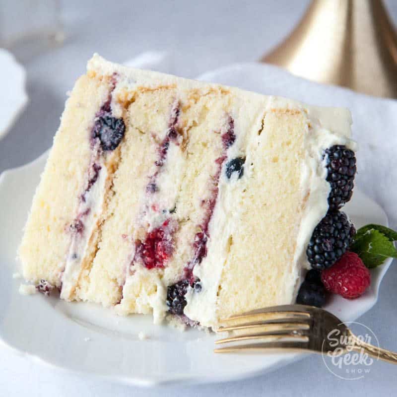 close up of a slice of berry chantilly cake
