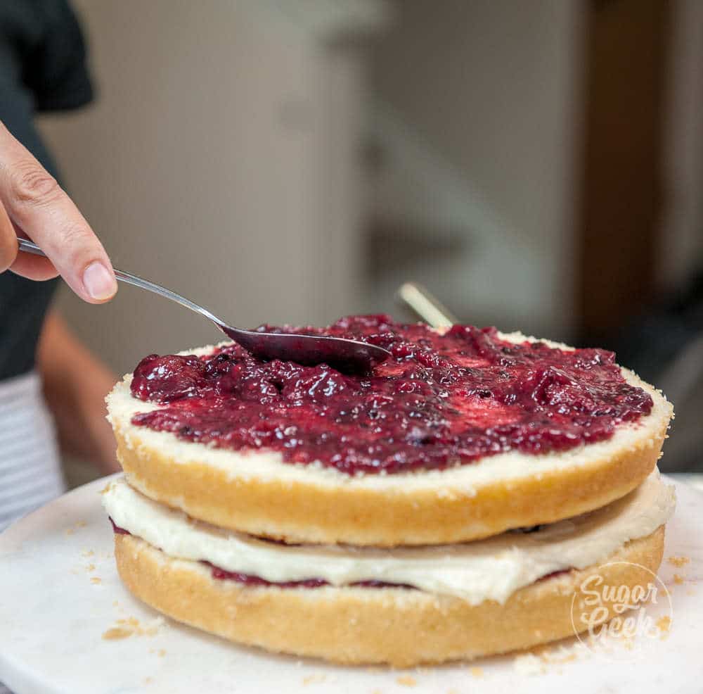 Stacking chantilly cake layers.