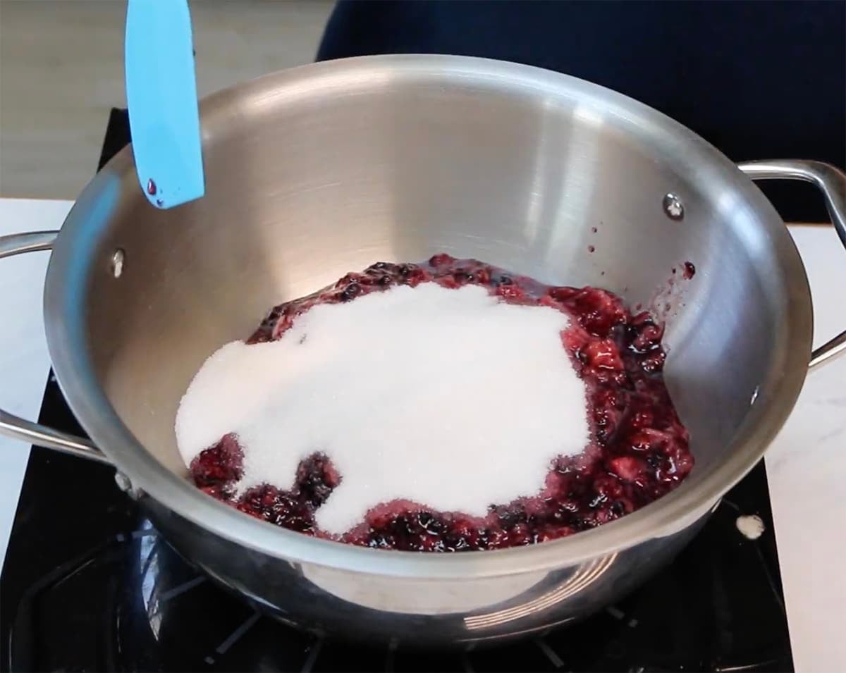 berries and sugar in a pot with sugar