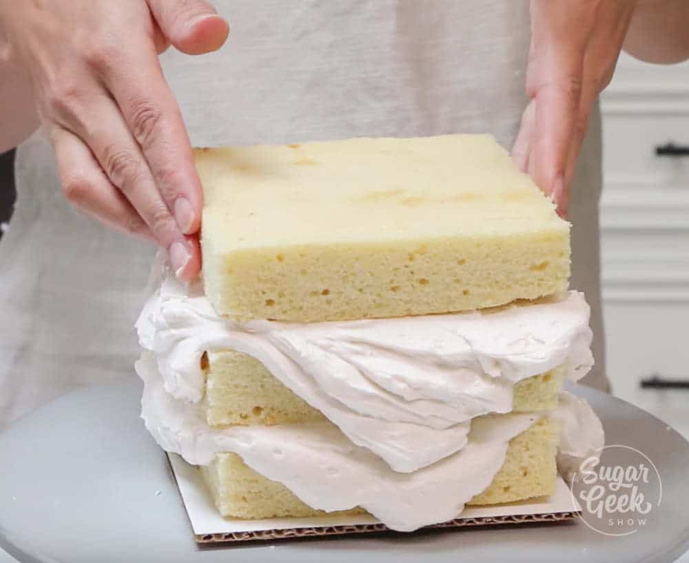 square cake tutorial - stacking trimmed cakes with buttercream