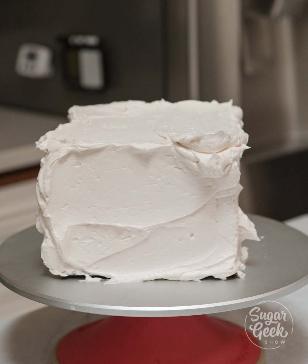 Square cake frosted in buttercream.