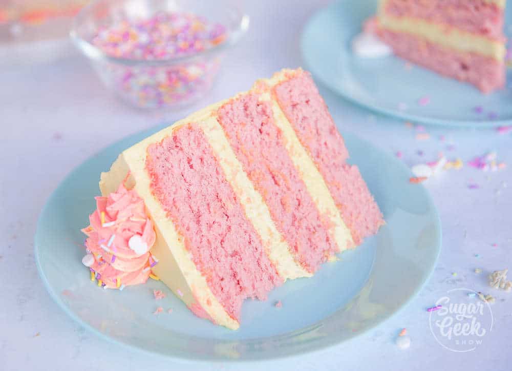 Slice of strawberry cake with lemon buttercream on a blue plate 