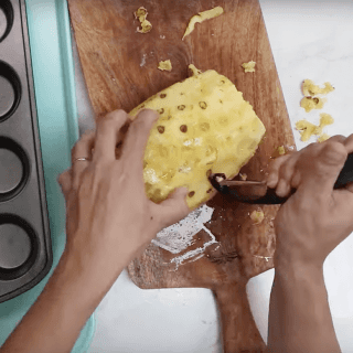 Use a potato peeler to dig out all the eyes of the pineapple