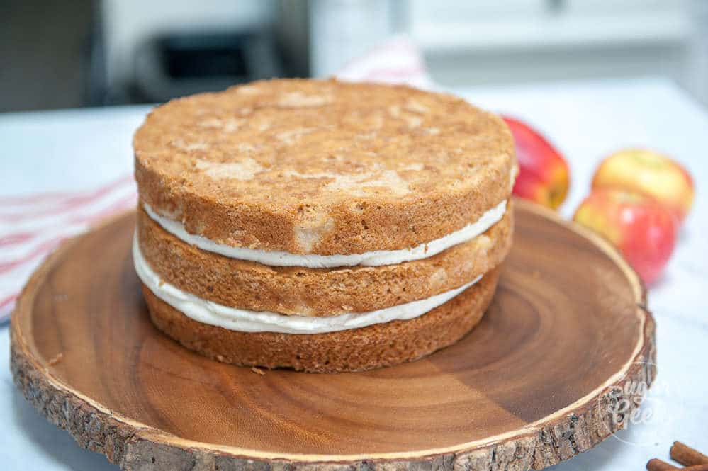 Three cake layers frosted in between and stacked.