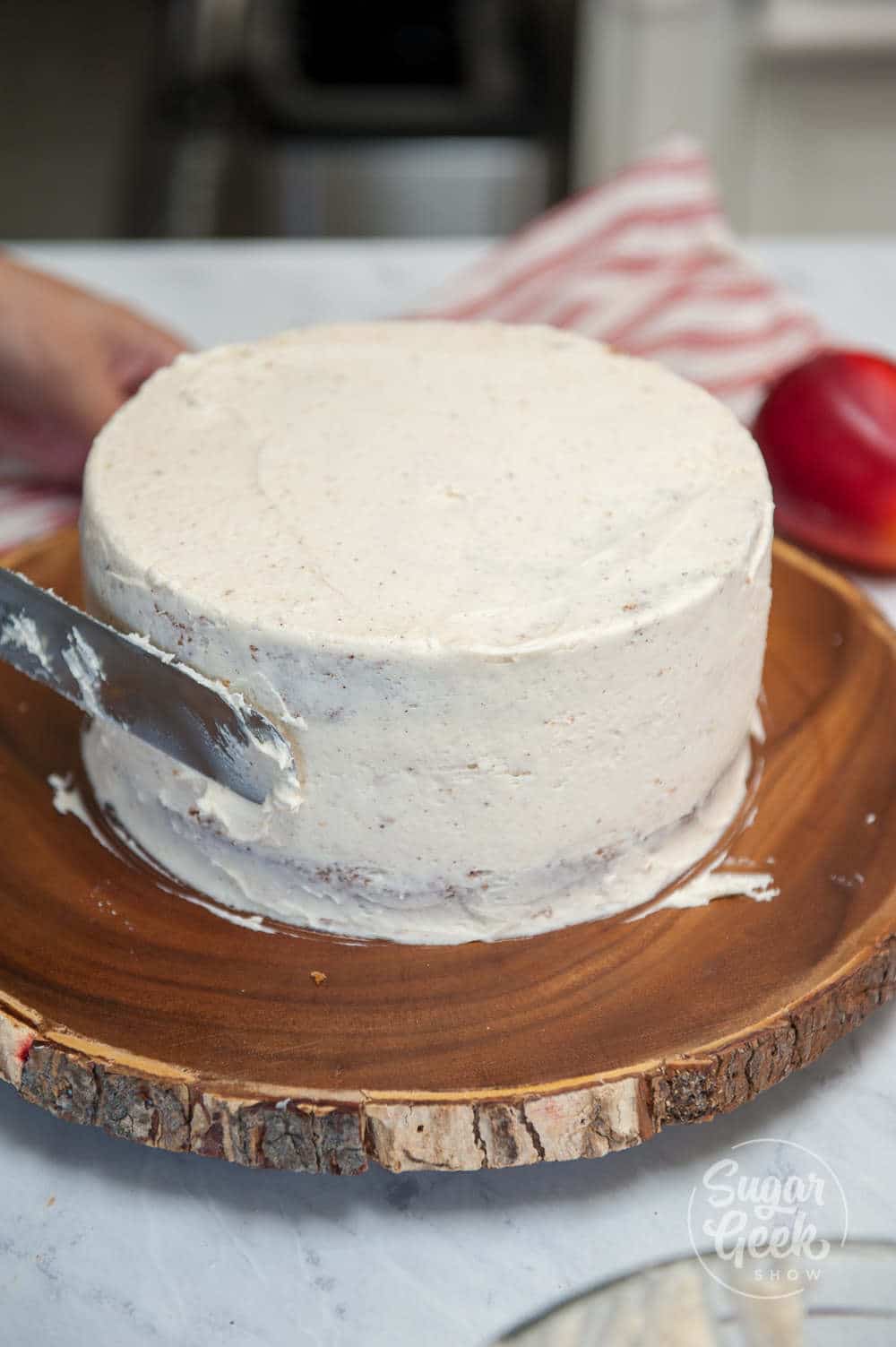 Cake layers frosted with the crumb coat.