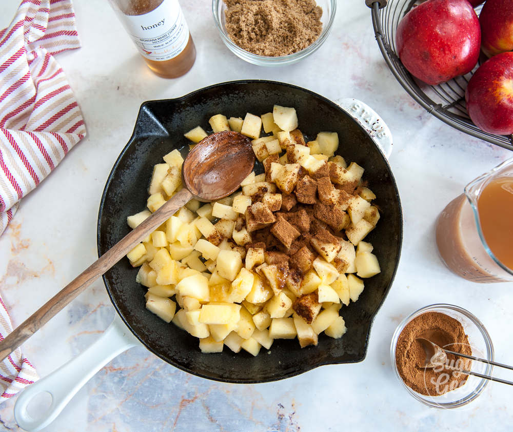 adding spices to cubed apples to make apple filling