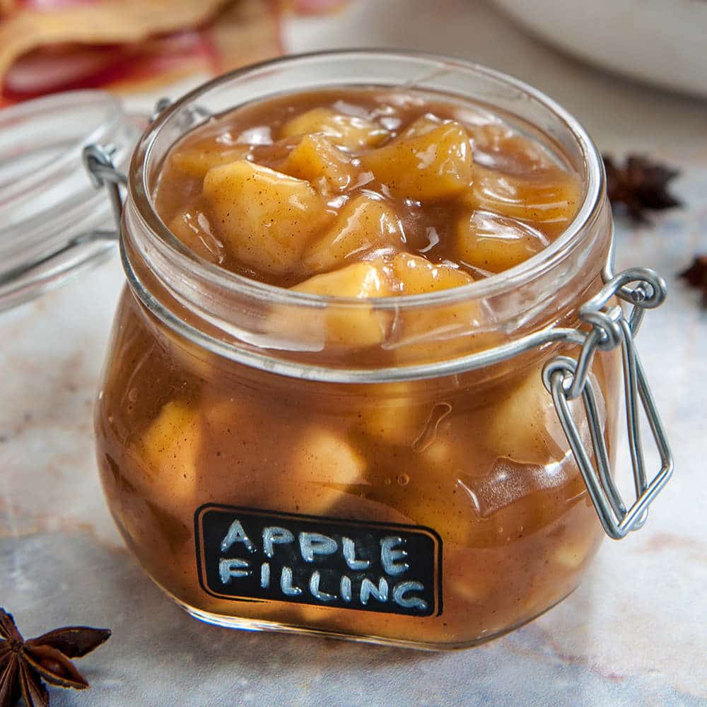 apple filling in glass jar with lid and black label on front that says apple filling