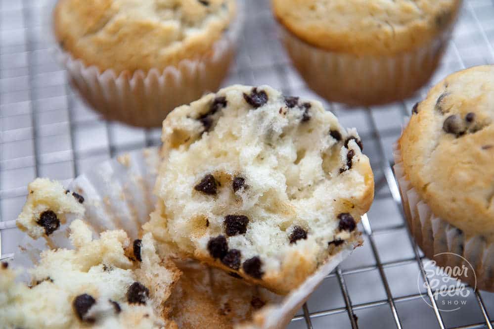 moist chocolate chip muffins split open on a cooling rack