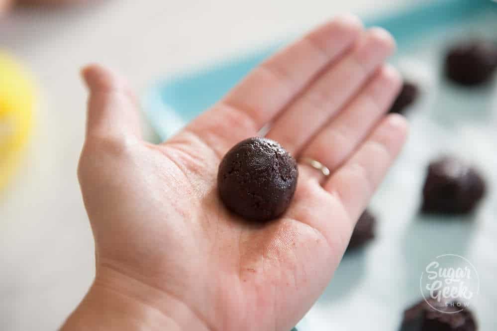 chocolate crinkle cookie dough rolled into a ball