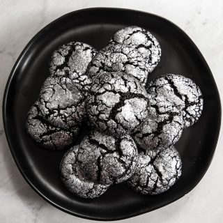 black plate with silver chocolate crinkle cookies