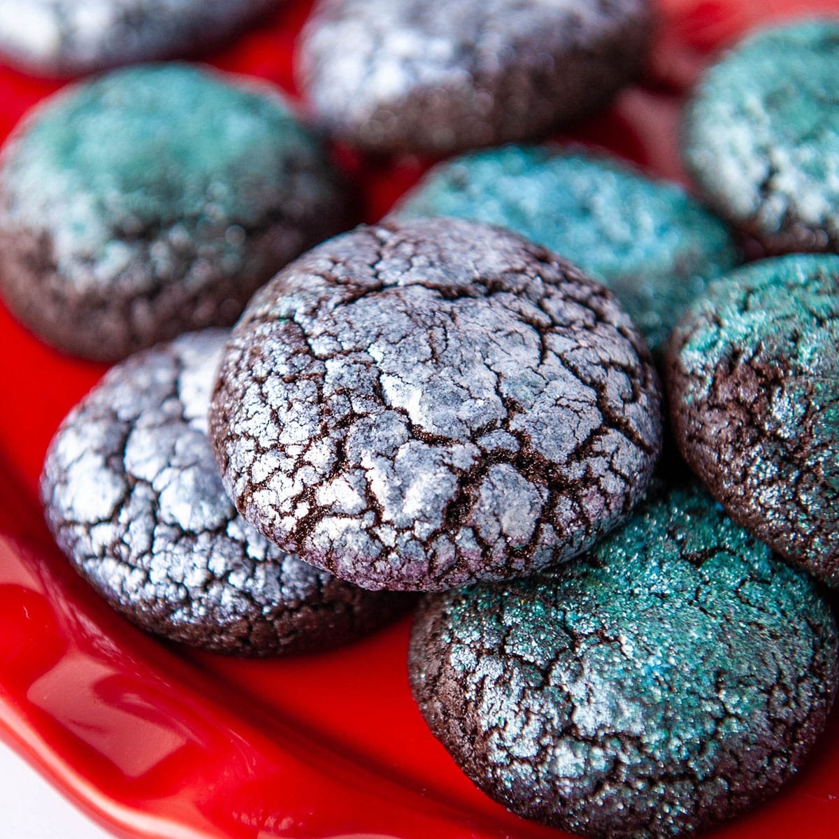 close up of glitter crinkle cookies on a red platter
